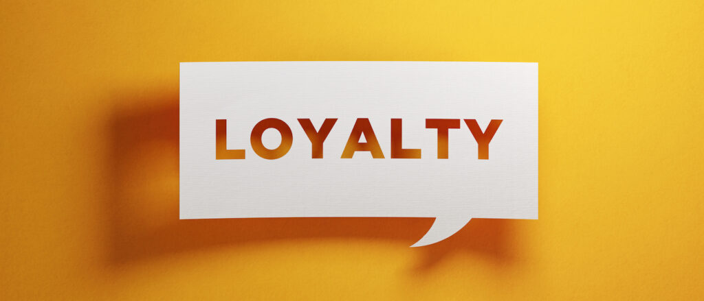 White chat bubble on yellow background with the word "loyalty" written on it
