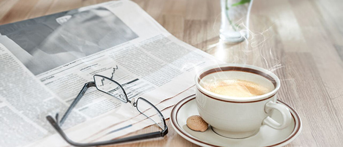 hot cup of coffee and newspaper