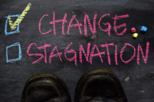 Change or Stagnation written with color chalk concept