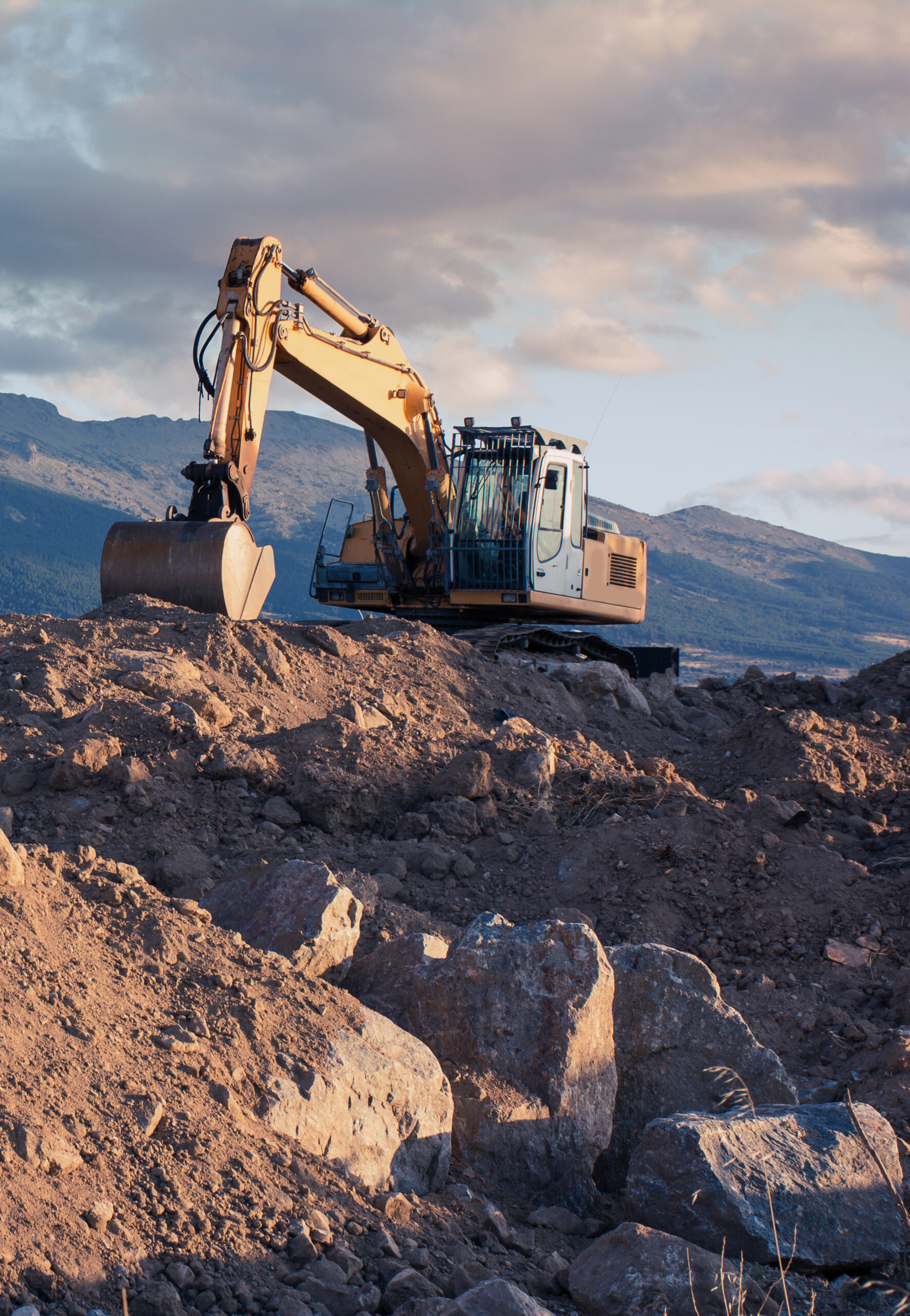 Excavator moving stone and earth