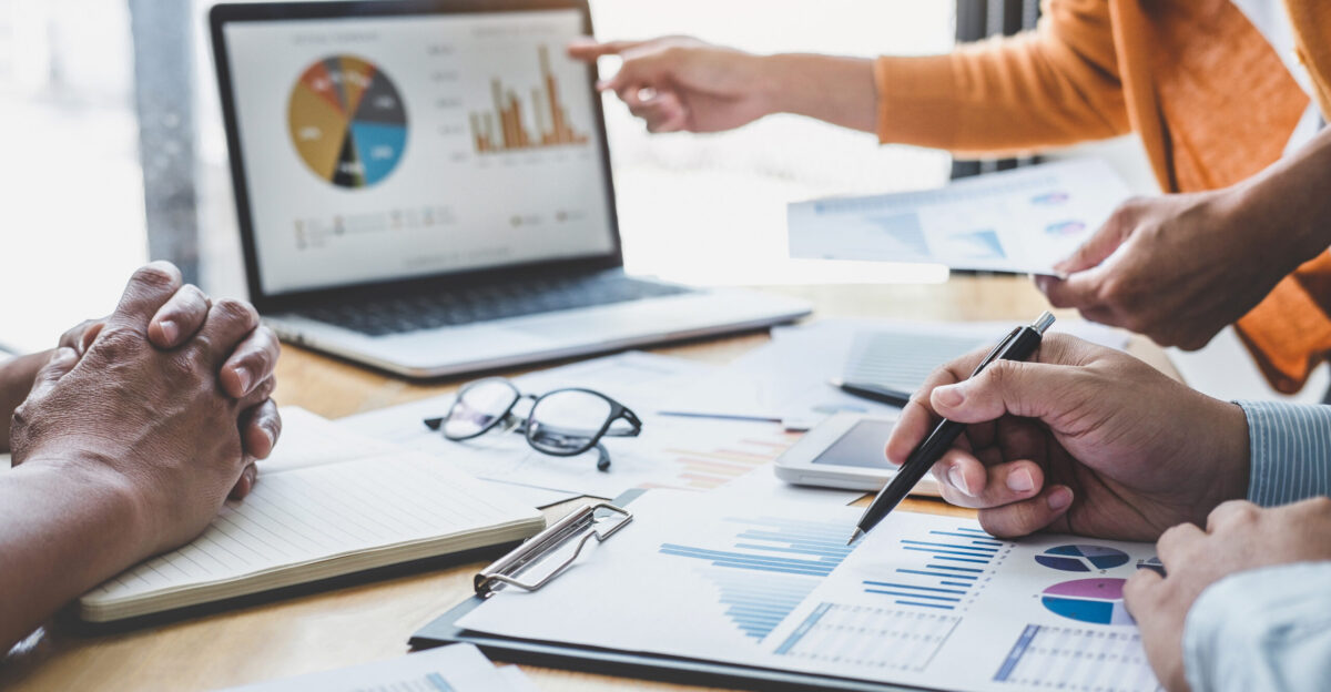Business team collaboration discussing working analyzing with financial data and marketing growth report graph in team, presentation and brainstorming to strategy planning broker consolidation