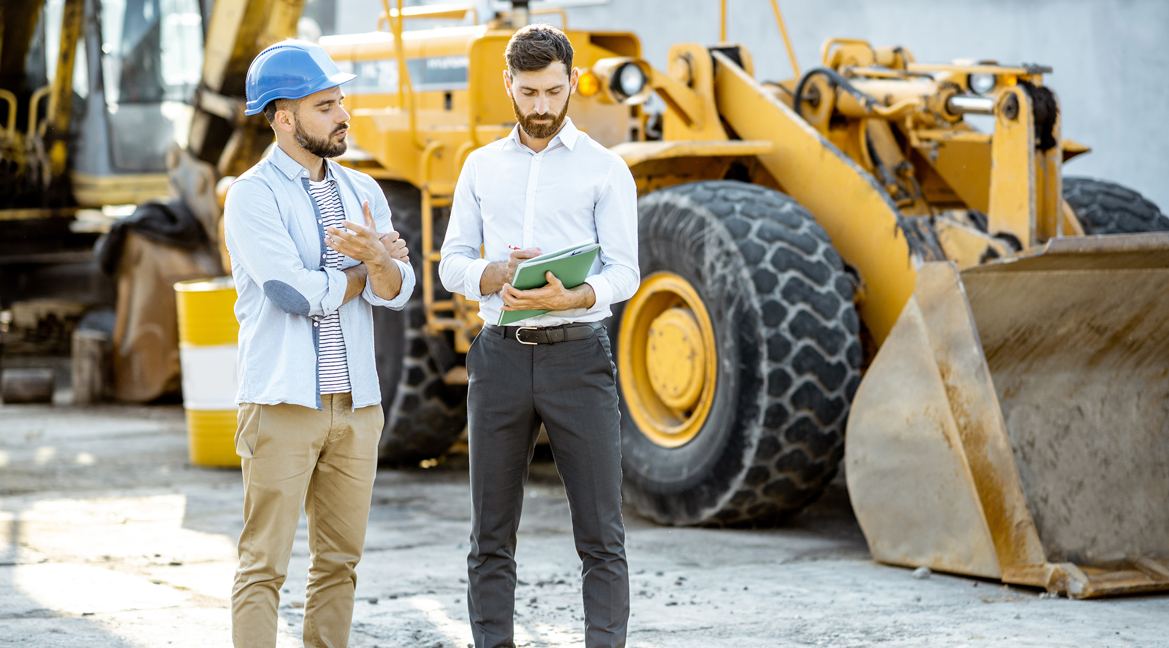 Equipment dealer discussing purchase details with prospective buyer.