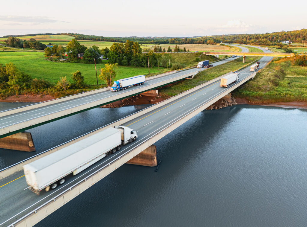 Semi trucks crossing tidal river bridges.