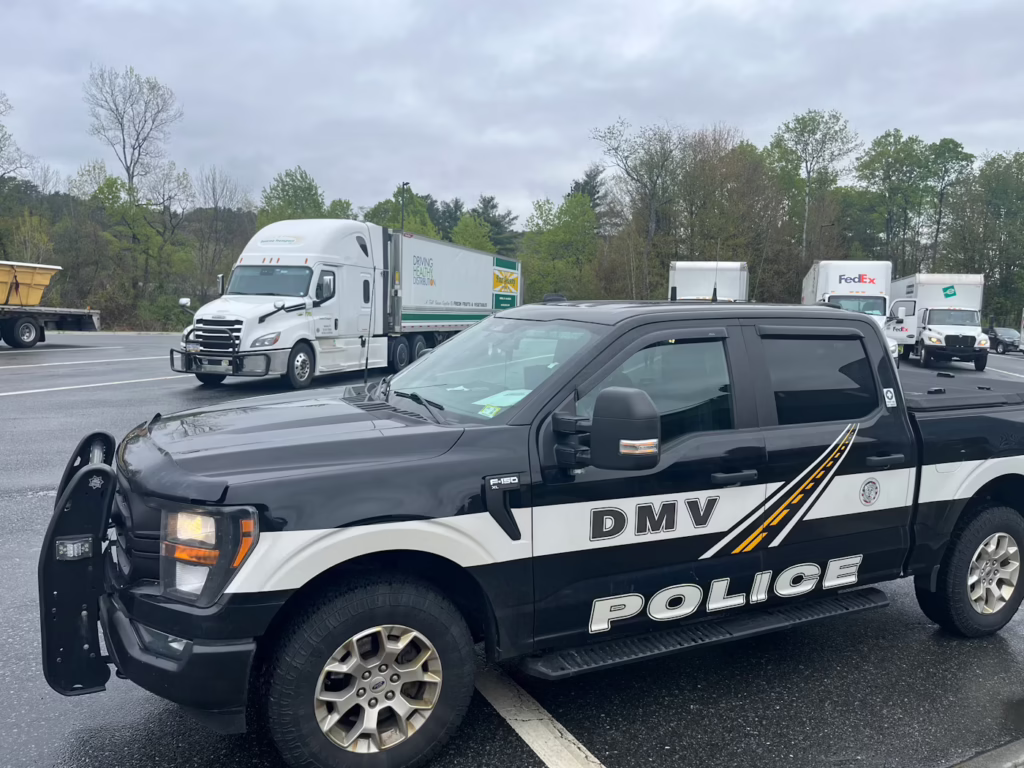 Police truck parked in front of semi trucks