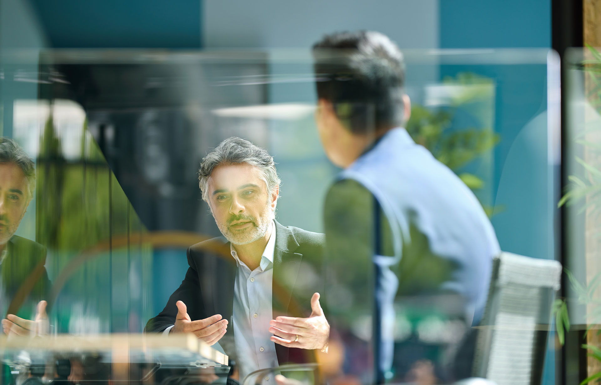Medium shot of businessman discussing insurance project with colleague